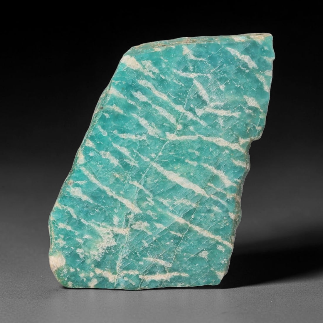 69ct Natural Russian Ural Amazonite Slab Rough, 51WV: This intact amazonite slab features distinct parallel mineral banding running uniformly across its naturally split flat surface within 44x28x6mm slab dimensions, retaining unmodified natural geologica