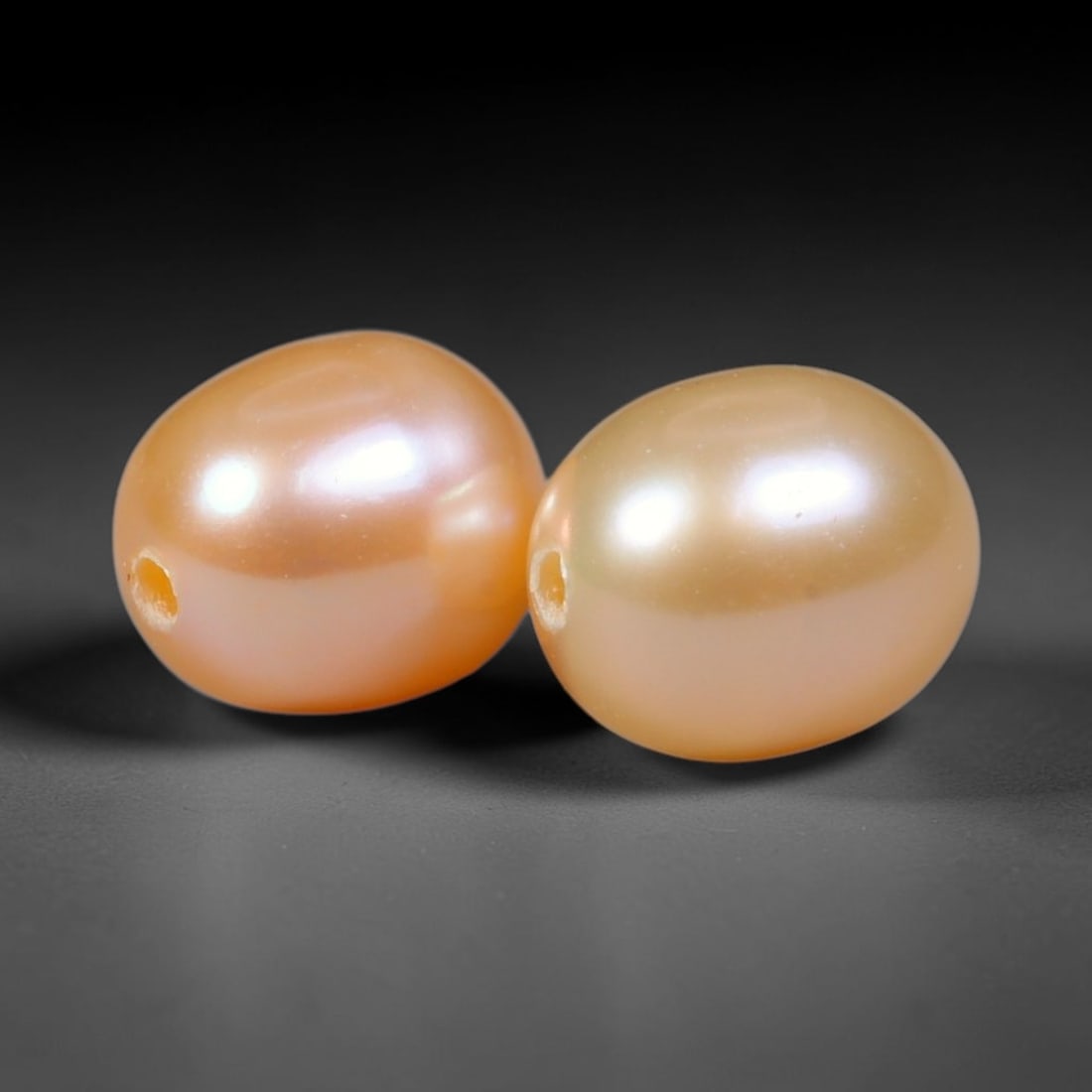 4.25ct Natural Peach Golden Orient Freshwater Egg Shape Pearl Pair, 64XZ: Matched pair of natural freshwater egg/oval pearls, uniform 7.5x6.2mm with clean through-drilled holes ready for jewelry setting. Each pearl features smooth silky nacre with a soft warm peach-gold bas