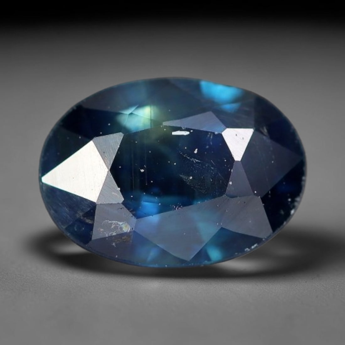 0.84 Carats Natural Teal Blue Sapphire Oval Loose Faceted Gemstone, 93XV: Natural moody teal-blue corundum sapphire masterfully cut into an oval brilliant loose gemstone, multi-facet design maximizes dual-toned blue-green color play and light sparkle. The gem displays deep 