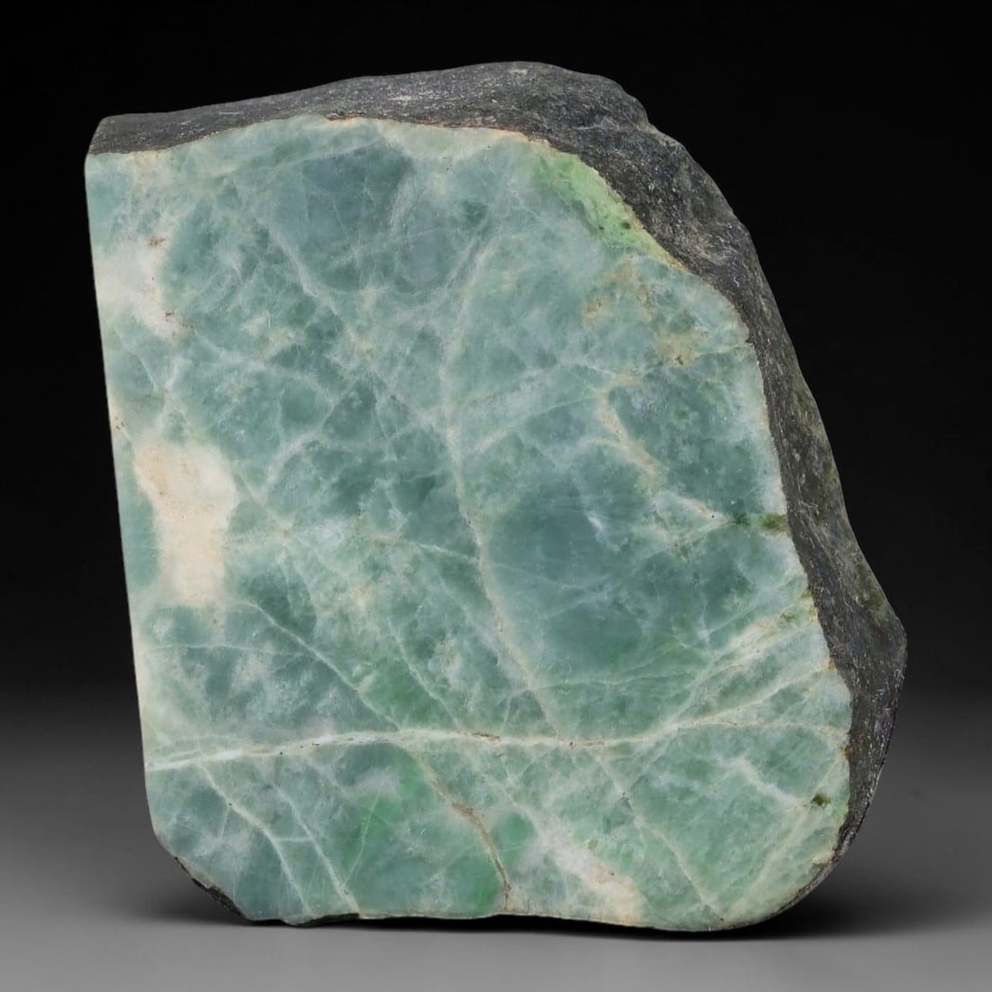 206ct Natural Type A Burmese Jadeite Jade Sliced Rough, 14YN: This specimen is a sliced rough block of natural Type A Burmese jadeite jade. The interior displays natural colour zoning with visible mineral veining and crystalline patterns typical of unprocessed j