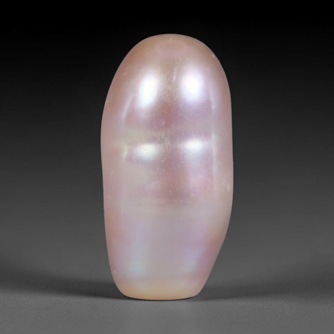 Natural Freshwater Baroque Pearl - Soft Dusty Pink Elongated Capsule Form, 69WE: This natural freshwater baroque pearl presents a smooth elongated capsule organic silhouette wrapped in luminous iridescent nacre, featuring soft dusty pink as the primary tone blended with faint lave