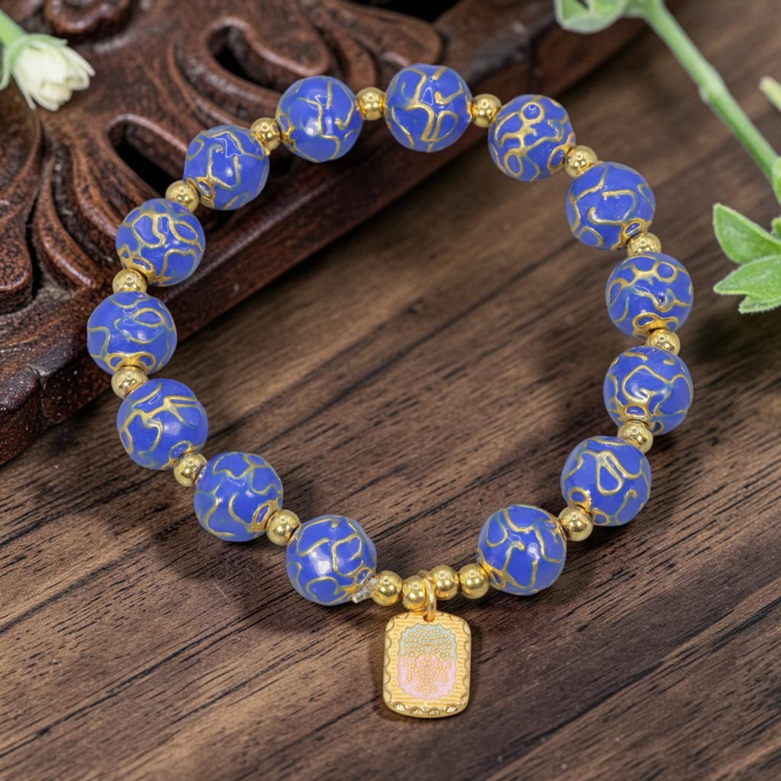 A Chinese Cloisonne Enamel Beaded Bracelet - Blue Gold-Tone Charm, 28YJ: This modern Chinese-style bracelet features 10.37mm round cloisonne enamel beads in a rich blue hue, each detailed with raised gold-tone wave-like patterns. Small smooth gold-tone spacer beads separat