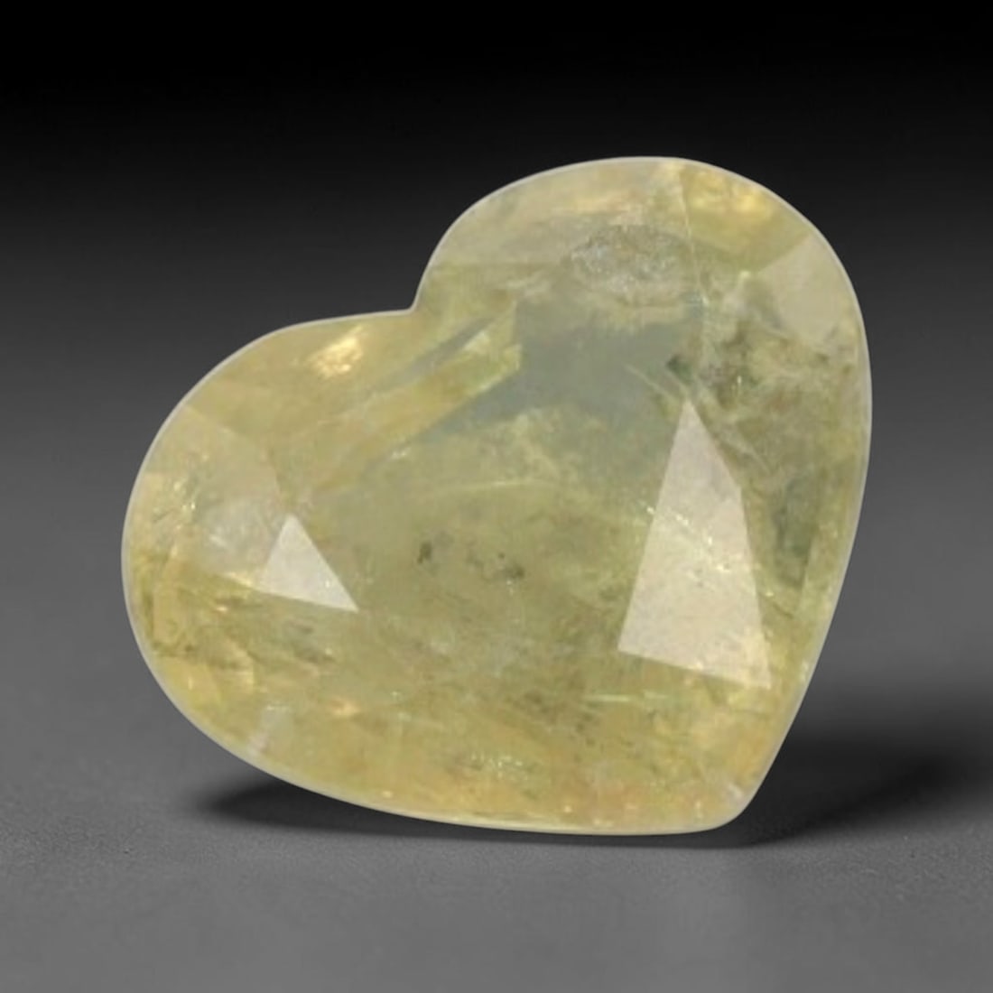 Certified 2.05 Carats Brownish Yellow Natural Ceylon Sapphire Single Heart Faceted Gemstone, LZ855: This single heart faceted natural sapphire presents warm muted brownish yellow tone with consistent saturation, precisely cut with balanced facets across its 7.08 mm x 8.36 mm x 4.07 mm measurements t