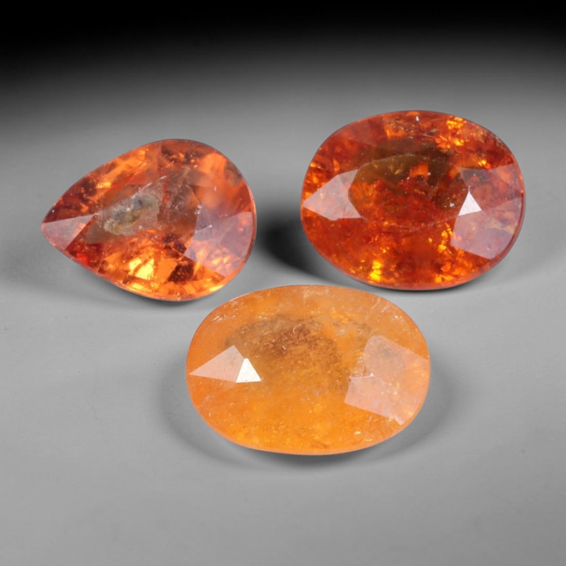 4.48 Carats Orange Spessartine Garnet - Faceted Gemstone, 80WE: Faceted spessartine garnet gemstone, crafted from natural spessartine garnet material. The stone exhibits a vibrant, saturated orange to fiery orange-red hue, with natural internal inclusions and subt