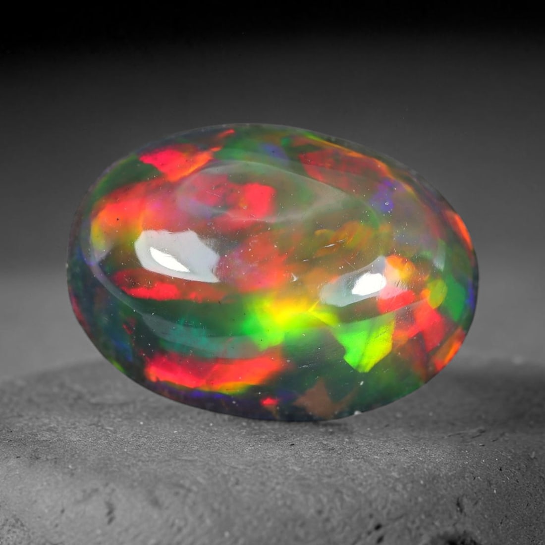2.00ct Natural Ethiopian Welo Black Smoked Opal Cabochon Loose Gemstone, 92WP: This fully polished Ethiopian Welo opal features a dark smoked base with vivid, sweeping play-of-color shifting across its glossy dome surface, measured at 10.3x7.7x4.8mm. The black smoke treatment de