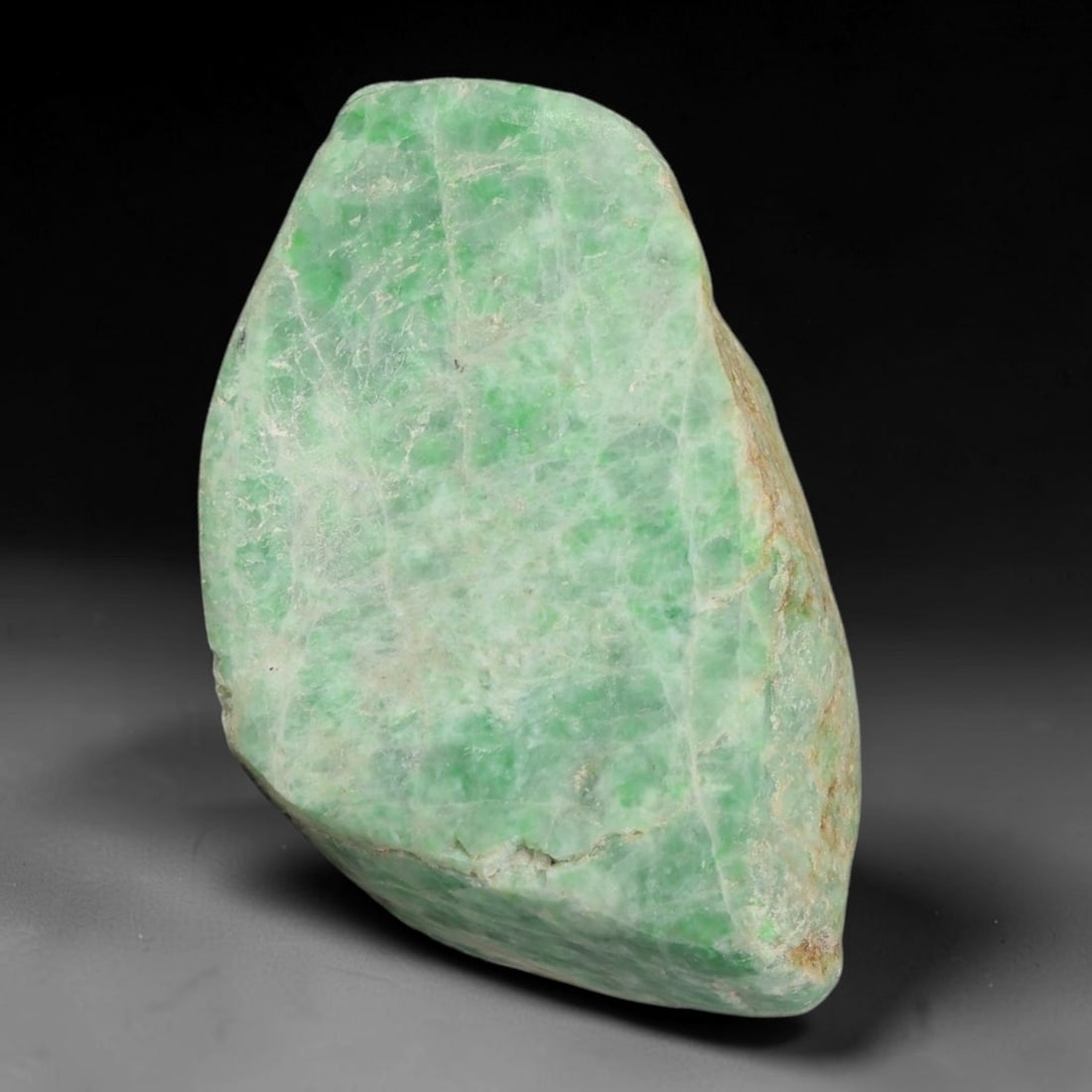 173ct Natural Type A Burmese Jadeite Jade Sliced Rough, 48YR: This specimen is a sliced rough block of natural Type A Burmese jadeite jade. The interior displays natural colour zoning with visible mineral veining and crystalline patterns typical of unprocessed j