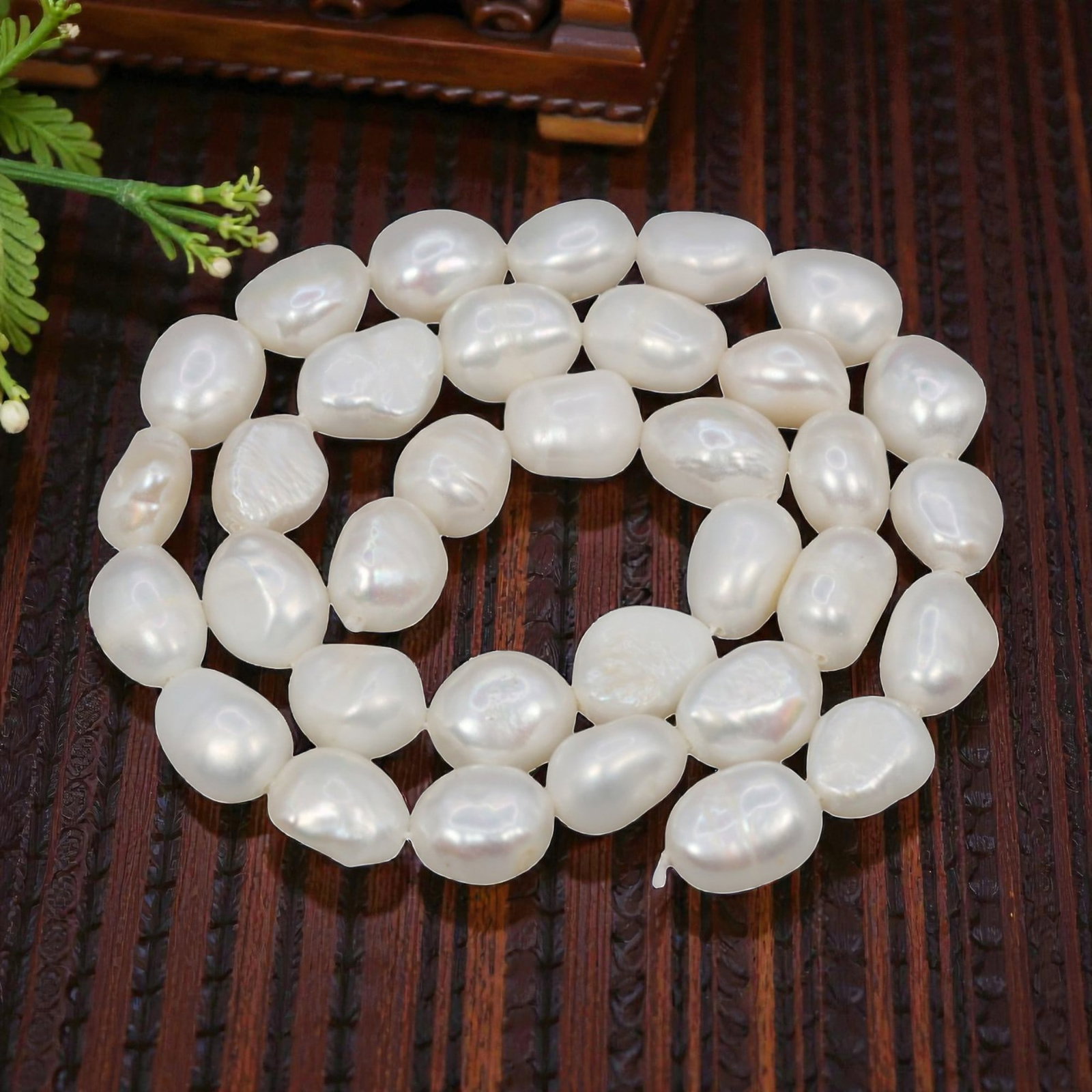 A Strand of Baroque Cultured Pearls, 20th Century, 81ZJ: Composed of baroque cultured pearls with an opaque white body color and subtle pearlescent overtones, the strand is strung in a single continuous line. Each pearl exhibits a distinct irregular, flatte
