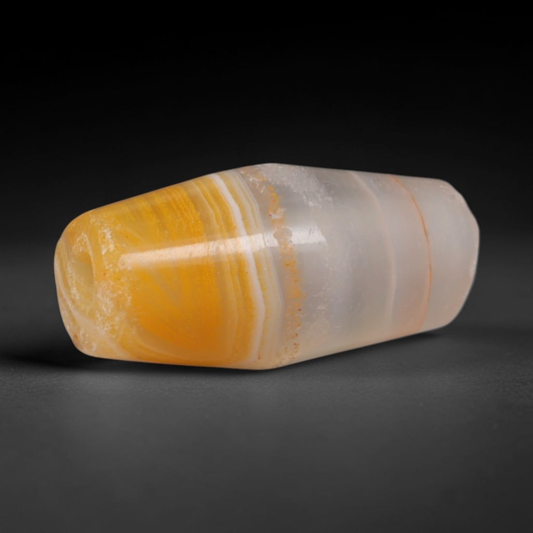 Ancient Parthian Two-Tone Honey Banded Agate Faceted Bicone Trade Bead (247 BCE - 224 CE), 33XD: This antique hand-faceted dual-toned banded agate bicone bead originates from Parthian Iranian stoneworking ateliers, makers of refined gradient chalcedony talismans circulated widely along westward S