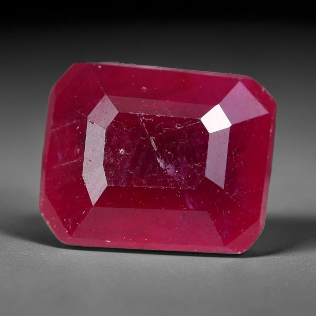 2.98 Carats Natural Madagascar Ruby Emerald Cut Loose Gemstone, 80XM: This natural Madagascar ruby is fashioned in a traditional emerald step faceted cut, showcasing deep saturated red tones typical of Malagasy corundum. Distinct natural internal fissures, fine mineral 