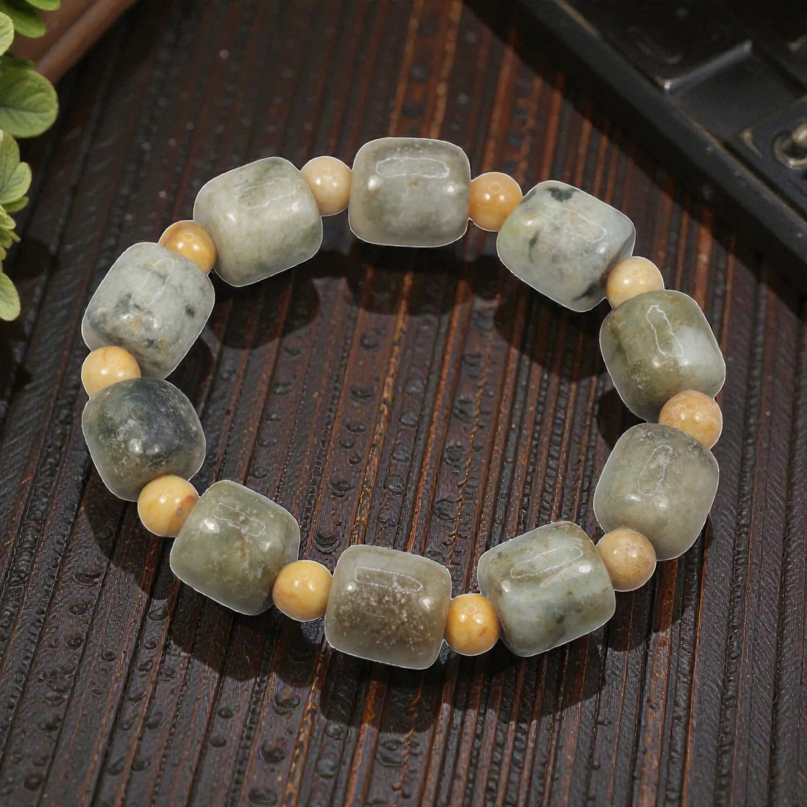 Natural Burmese Type A Jadeite Jade Bead Bracelet, 20th Century, 38ZK: Composed of a single strand of cuboid and spherical jadeite jade beads forming a circular bracelet. The cuboid beads display natural tonal variation from pale green to deep green, with visible interna