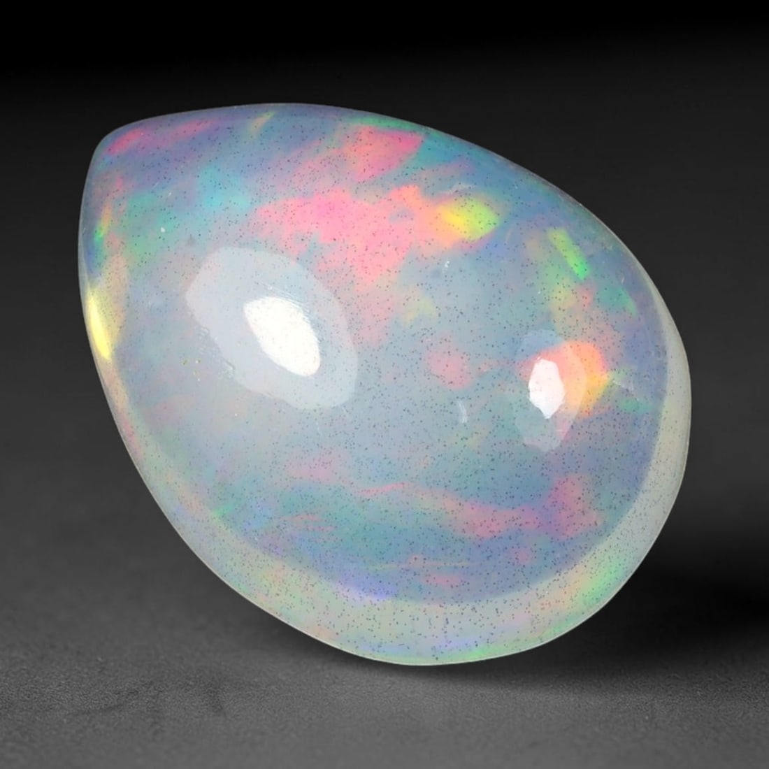 9.88ct Natural Multicolor Fire Ethiopian Welo Solid Opal Cabochon Loose Gemstone, 10TG: Formed from natural silica deposits within Ethiopian mineral veins, this solid opal cabochon is polished to a smooth domed surface that displays inherent light refraction traits. The stone carries wid