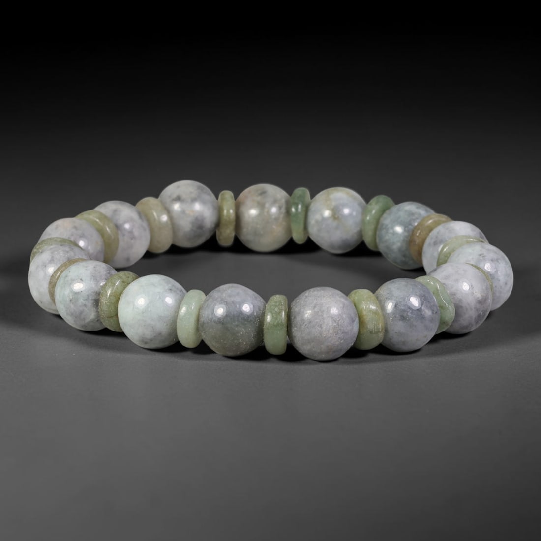 Natural Burmese Type A Grey Ink Jadeite with Spacer Disc Beaded Bracelet, 55TA: Handcrafted from fully untreated authentic Burmese Type A jadeite, this bracelet features smooth round grey ink jade beads separated by alternating pale green and light yellow jade spacer discs. The m