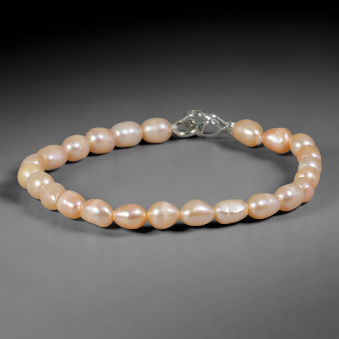 Natural Freshwater Pearl Bracelet - Baroque Peach Blush Pearl Strand, 78YM: Composed of petite organic baroque natural freshwater pearls carrying soft peach blush pearlescent luster, each bead holding delicate asymmetrical oval shapes formed through unrefined natural freshwat