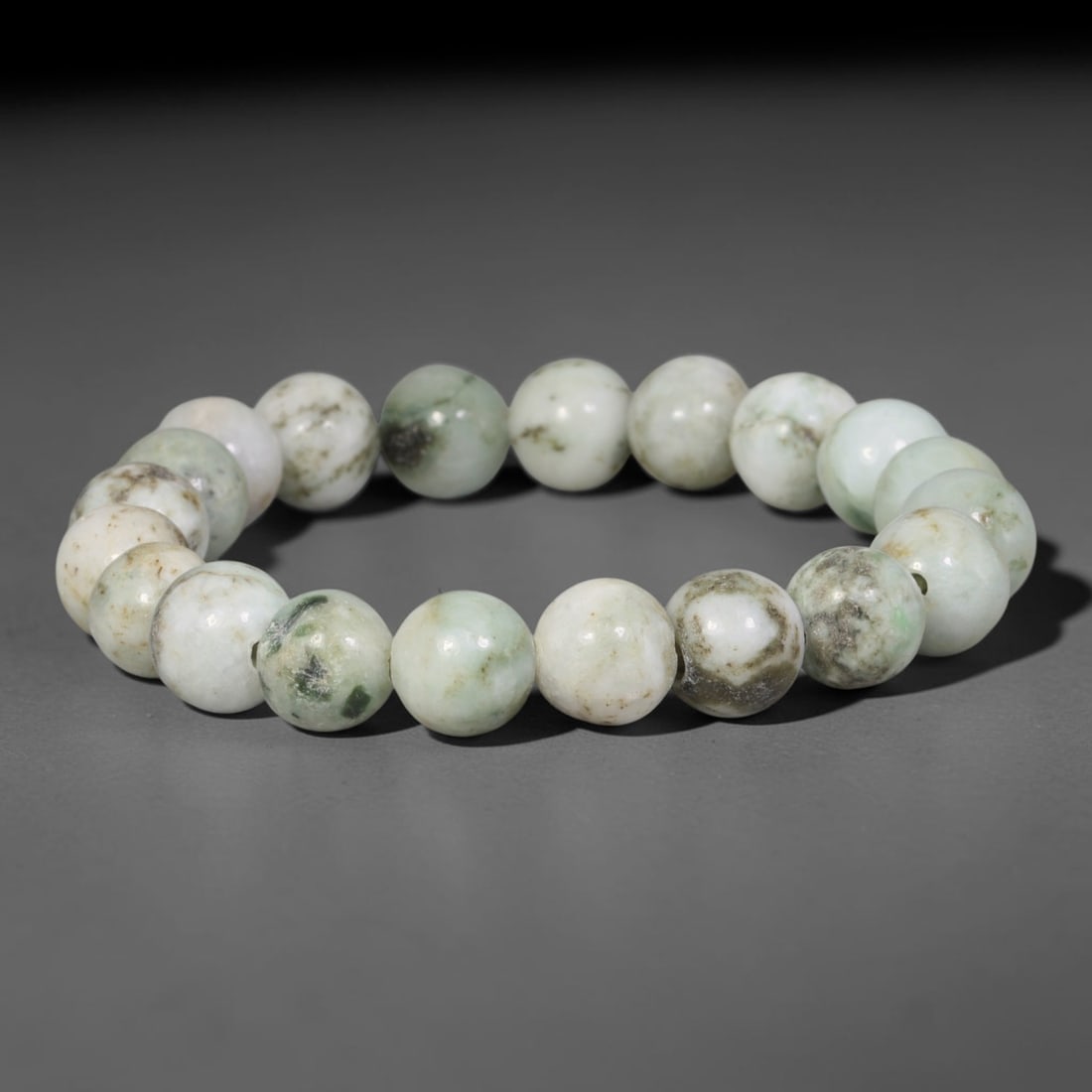 Natural Burmese Type A White Base Dark Moss & Brown Speckled Jadeite Bracelet, 86TA: Handcrafted from fully untreated natural Burmese Type A jadeite, this bracelet features smooth medium round beads with a milky white foundation naturally dotted with dark moss green flecks and earthy 