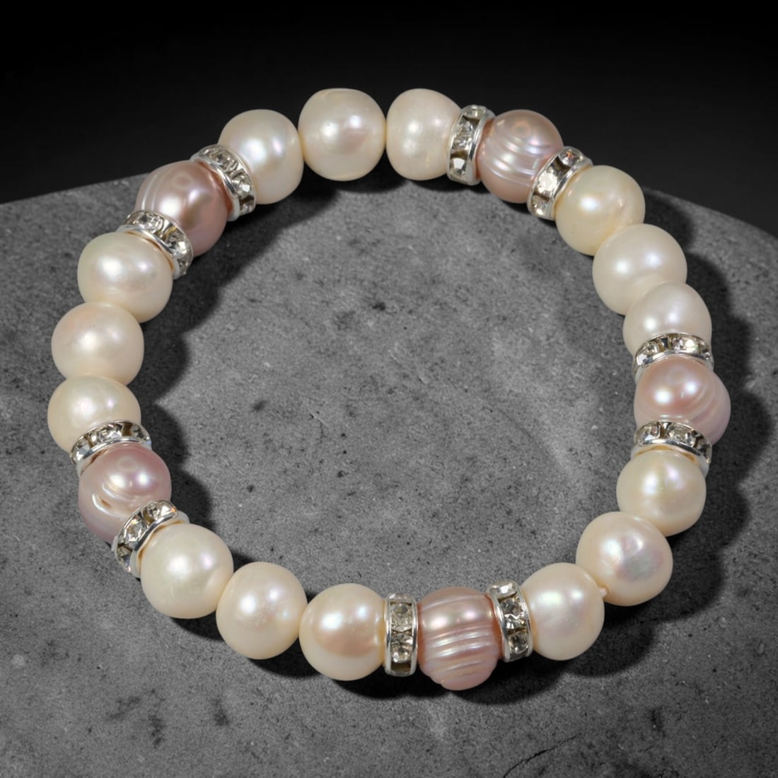 Natural Freshwater Pearl Beaded Bracelet - 9mm Baroque Pearl Strand, 45YM: This elastic stretch bracelet is strung with 9mm natural freshwater baroque pearls, separated by silvered metal spacers set with clear crystalline accents. Each pearl bears organic irregular natural c