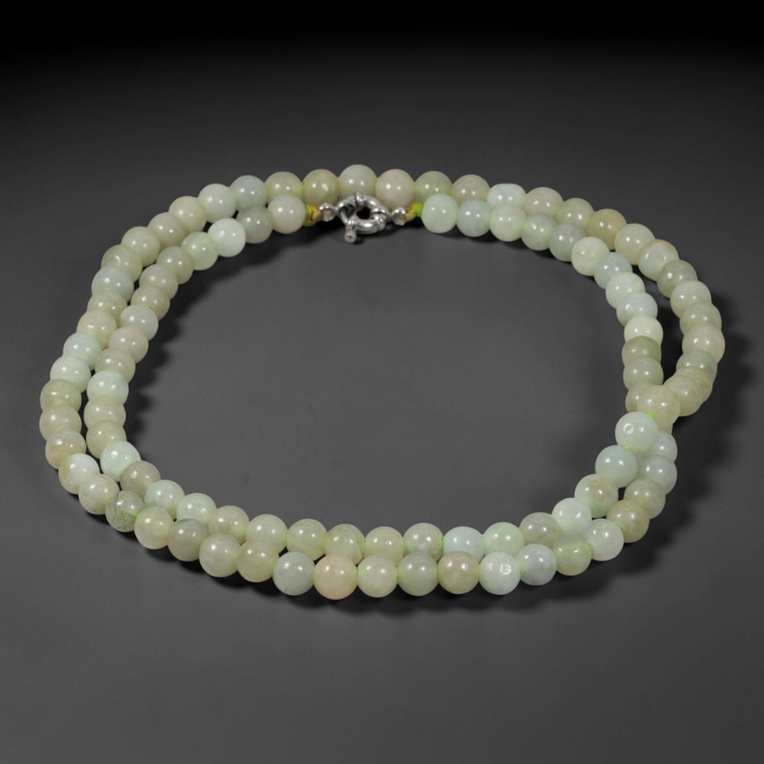 Natural Burmese Type A Pale Celadon Jadeite Jade Beaded Necklace, 7TF: Strung from untreated natural Burmese Type A jadeite jade spherical beads measuring 7.75mm in diameter, this full strand holds a uniform smooth polished finish showing soft pale celadon mineral hues b