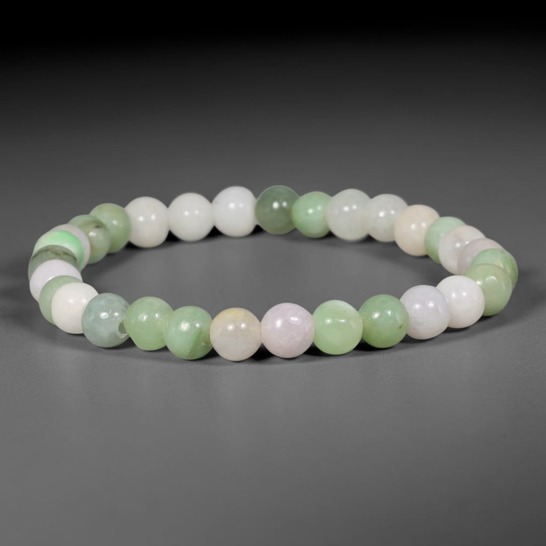 Natural Burmese Type A Multi-Colour Jadeite Jade Beaded Bracelet, 82TA: Strung from untreated natural Burmese Type A jadeite jade spherical beads with maximum bead dimension of 7.32mm, this bracelet strand features a sleek smooth polished finish showcasing mixed pale gree
