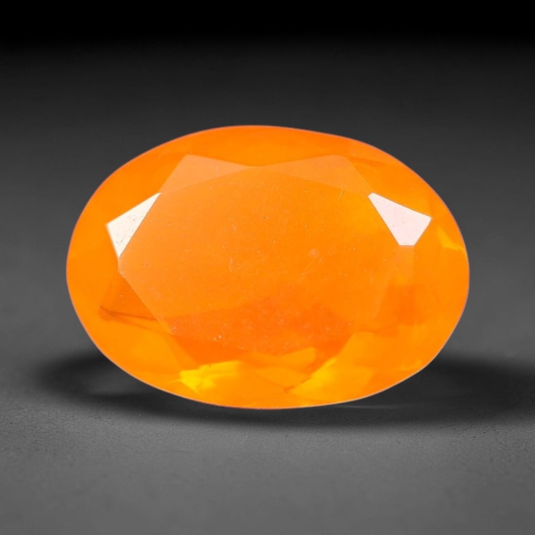 1.39 Carats Natural Ethiopian Welo Orange Fire Opal Oval Faceted Loose Gemstone, 76XX: This opal material is mined from the Welo deposits of Ethiopia and processed with professional faceted lapidary work with uniform polished facets across the gem surface. Natural subtle internal textur
