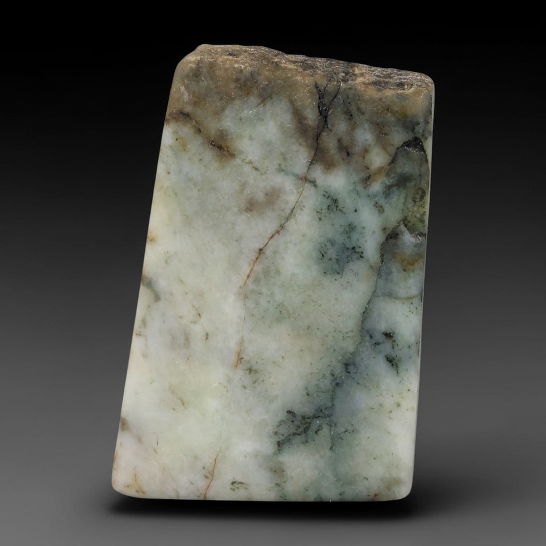 265ct Natural Type A Burmese Jadeite Jade Sliced Rough, 41YR: This specimen is a sliced rough block of natural Type A Burmese jadeite jade. The interior displays natural colour zoning with visible mineral veining and crystalline patterns typical of unprocessed j
