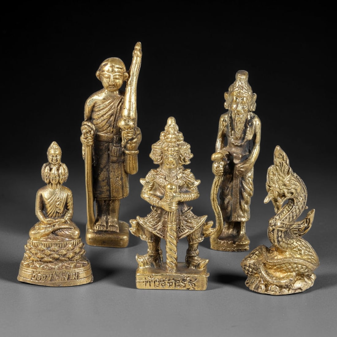Thai Vintage Copper Alloy Mixed Buddhist Guardian & Naga Mini Statues - 5pcs Set, 5YZ: Vintage Thai copper alloy spiritual figurine set including five distinct mini statues, each sized 5.0x1.5cm. The collection consists of multi-headed seated Buddha, pilgrimage monk carrying staff, arme
