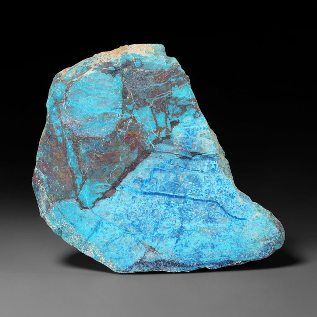 104ct Natural Peruvian Chrysocolla Polished Slab Rough, 52WV: This partial-polished chrysocolla slab features blended mineral matrix with smooth refined face and unaltered natural rugged edge across its 48x40x7mm elongated form, translucent mineral layers hold s