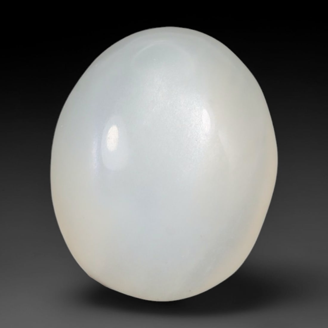 9.25 Carats Natural Ceylon Soft Milky White Moonstone Oval Cabochon Loose Gemstone, 80WS: This soft milky white Ceylon moonstone oval cabochon possesses a smooth, uniform translucent cream base with subtle diffused adularescent glow spreading evenly across its low domed polished surface. T