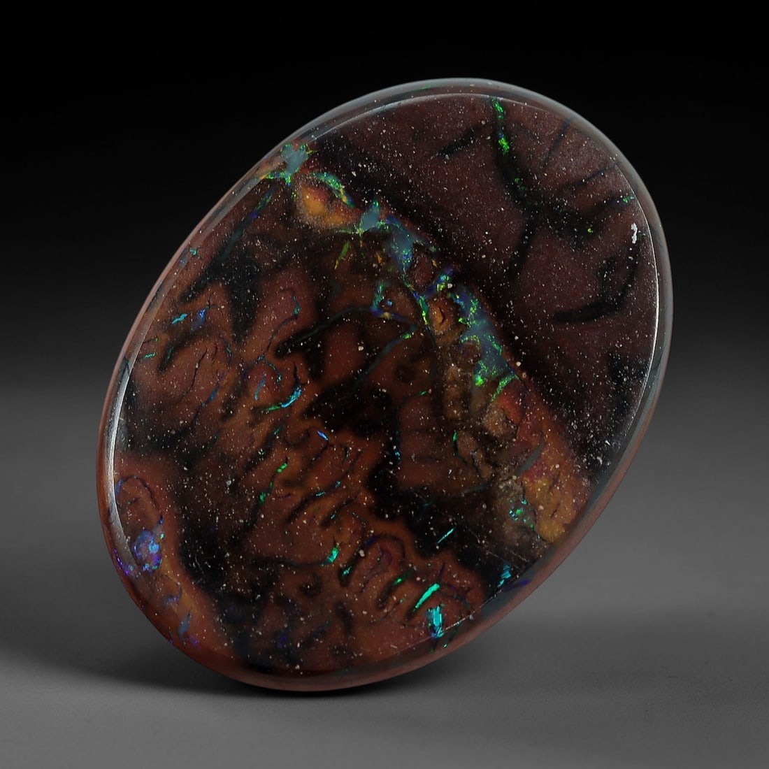 3.82 Carats Koroit Boulder Opal Cabochon - Natural Australian Stones 12.8x9.5mm, 7XM: This exceptional 3.82-carat Koroit boulder opal cabochon is a natural geological masterpiece, featuring a dense, intricate matrix of swirling chocolate-brown and deep plum ironstone, interwoven with v