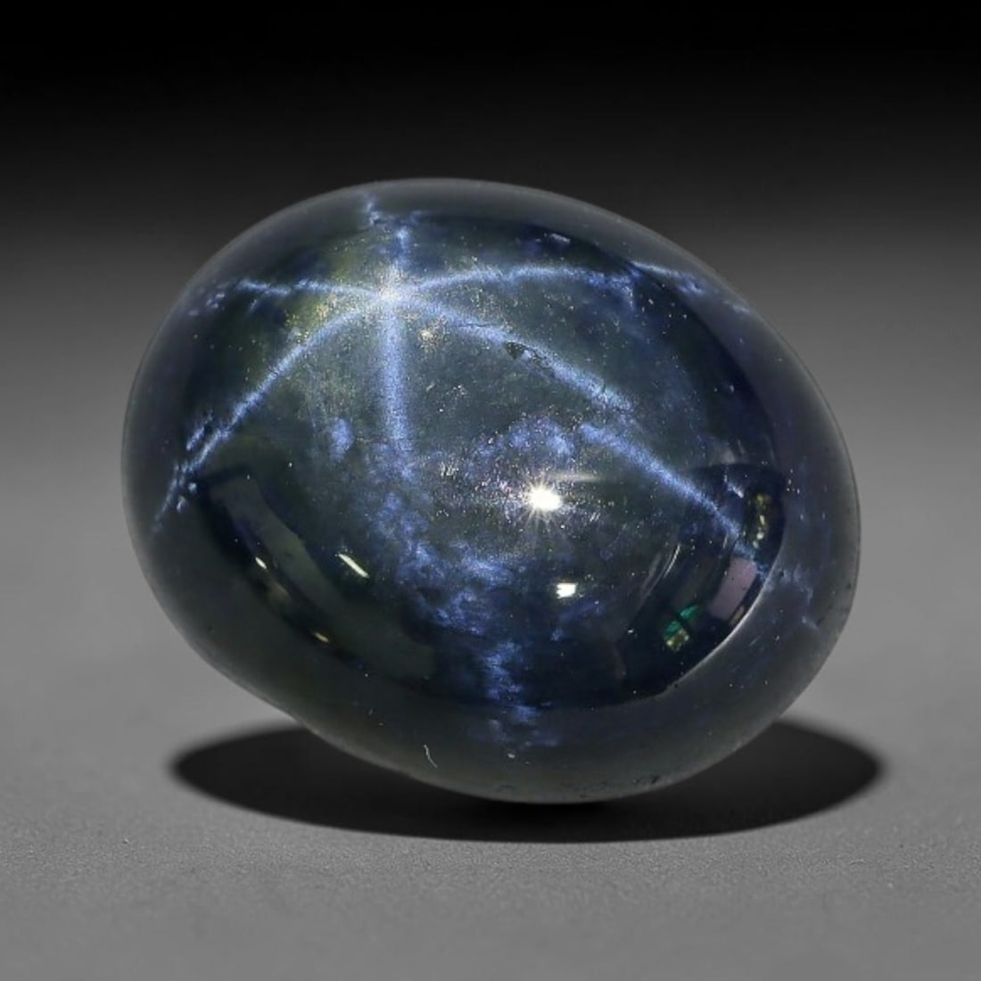8.07 Carats Natural 6 Ray Blue Star Sapphire Loose Gemstone, 48XX: This star sapphire is crafted from natural corundum deposits and refined into a sleek polished cabochon form through professional lapidary finishing procedures. The distinct six-ray star asterism disp