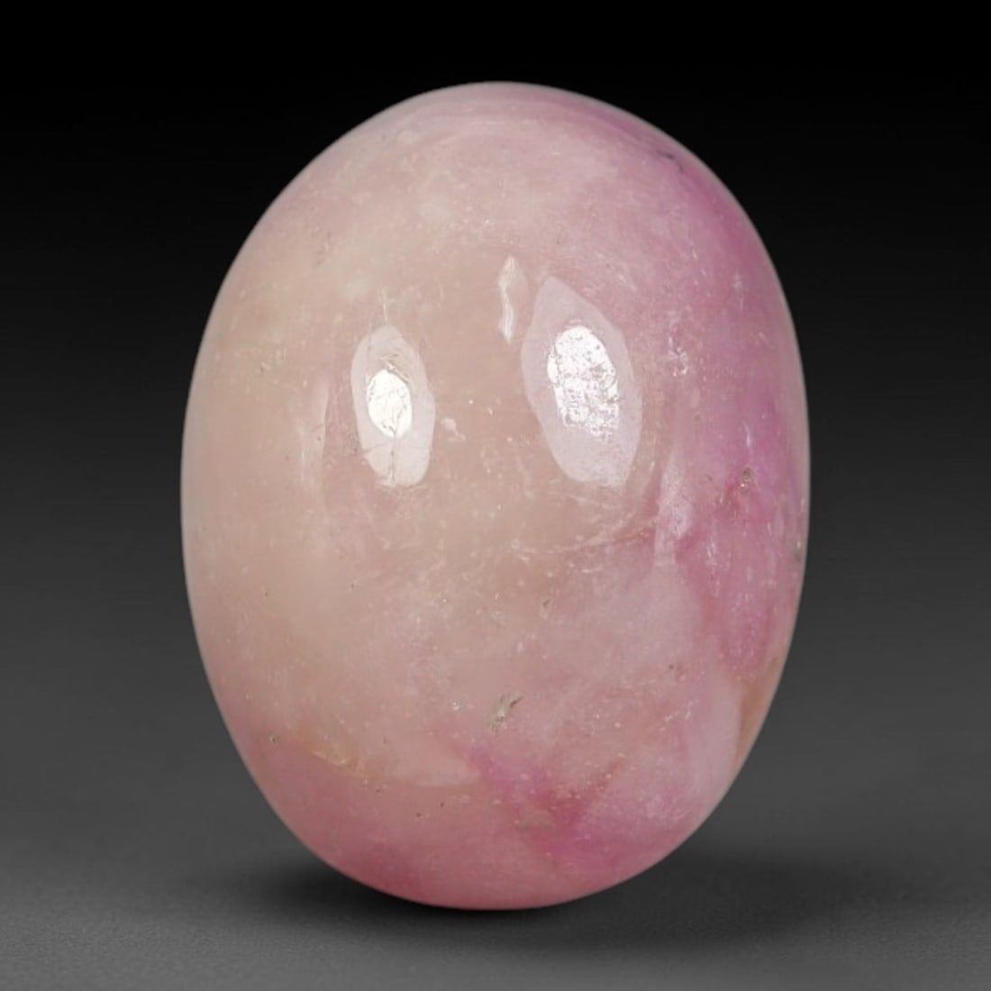 10.29 Carats Natural Madagascar Soft Pastel Pink Heated Ruby Oval Cabochon Loose Gemstone, 92WS: This gentle pastel pink ruby cabochon carries soft blended washes of pale blush and deeper rose pink with faint natural mineral veining scattered across its polished dome, measured at 13.4x10.2x6.8mm.
