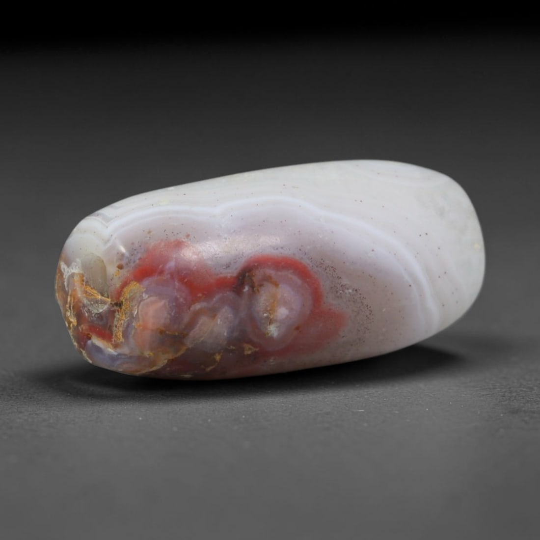 Ancient Gandhara Natural Red Cloud Eye Banded Agate Slim Barrel Trade Bead (600 BCE - 500 CE), 41XD: This slender antique banded agate barrel bead was crafted in Gandhara's multicultural stoneworking ateliers, revered as rare natural eye talismans by Buddhist pilgrims and Silk Road caravan traders. C