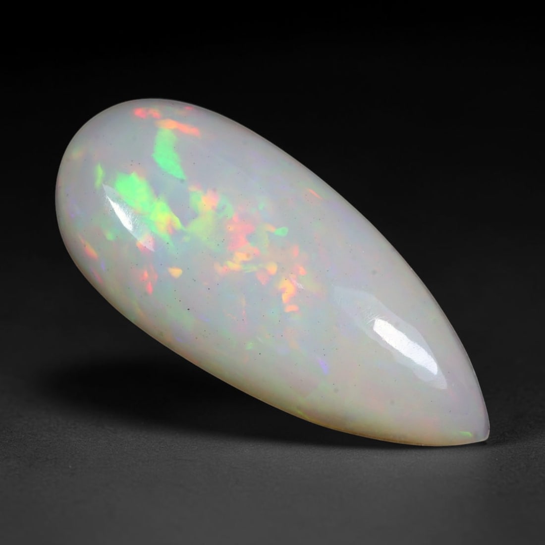 8.87ct Natural Ethiopian Welo Solid Opal Pear Cabochon Loose Gemstone, 18TG: Solid opal cabochon sourced from Ethiopia's Welo opal mining deposits, polished into a long slender pear teardrop domed shape with consistent high-gloss surface finish. The pale milky translucent matr