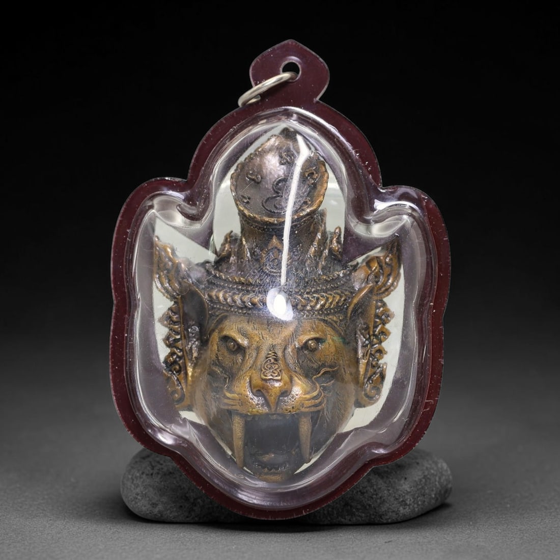 Thai Metal Tiger Head Amulet - Resin Cased Votive Pendant, 2YY: Cast metal devotional talisman crafted as detailed crowned tiger head with prominent fangs, layered decorative headgear and etched symbolic markings across the facial surface. The reverse side bears i