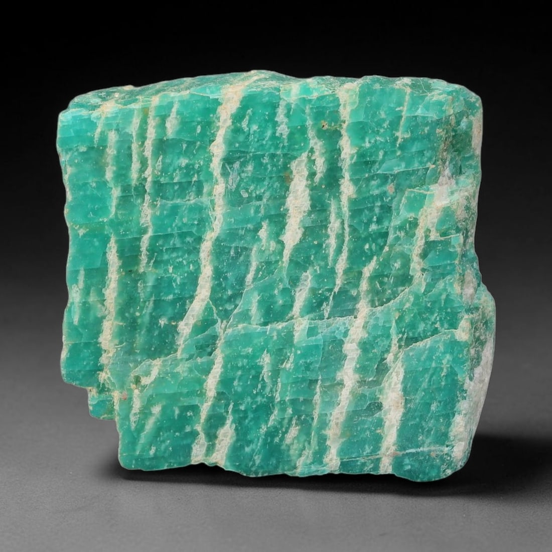 61ct Natural Russian Ural Amazonite Slab Rough, 57WV: This intact amazonite slab features distinct parallel mineral banding running uniformly across its naturally split flat surface within 32x29x6mm slab dimensions, retaining unmodified natural geologica
