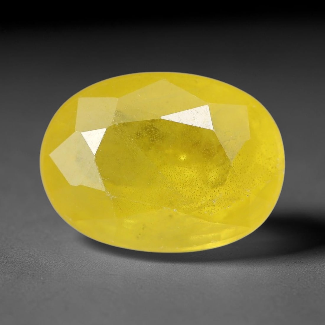 3.81 Carats Natural Yellow Sapphire Oval Faceted Loose Gemstone, 48XM: This natural yellow sapphire features a classic oval brilliant faceted cut, holding consistent warm golden-yellow color throughout the corundum crystal. Fine microscopic mineral specks and faint natur