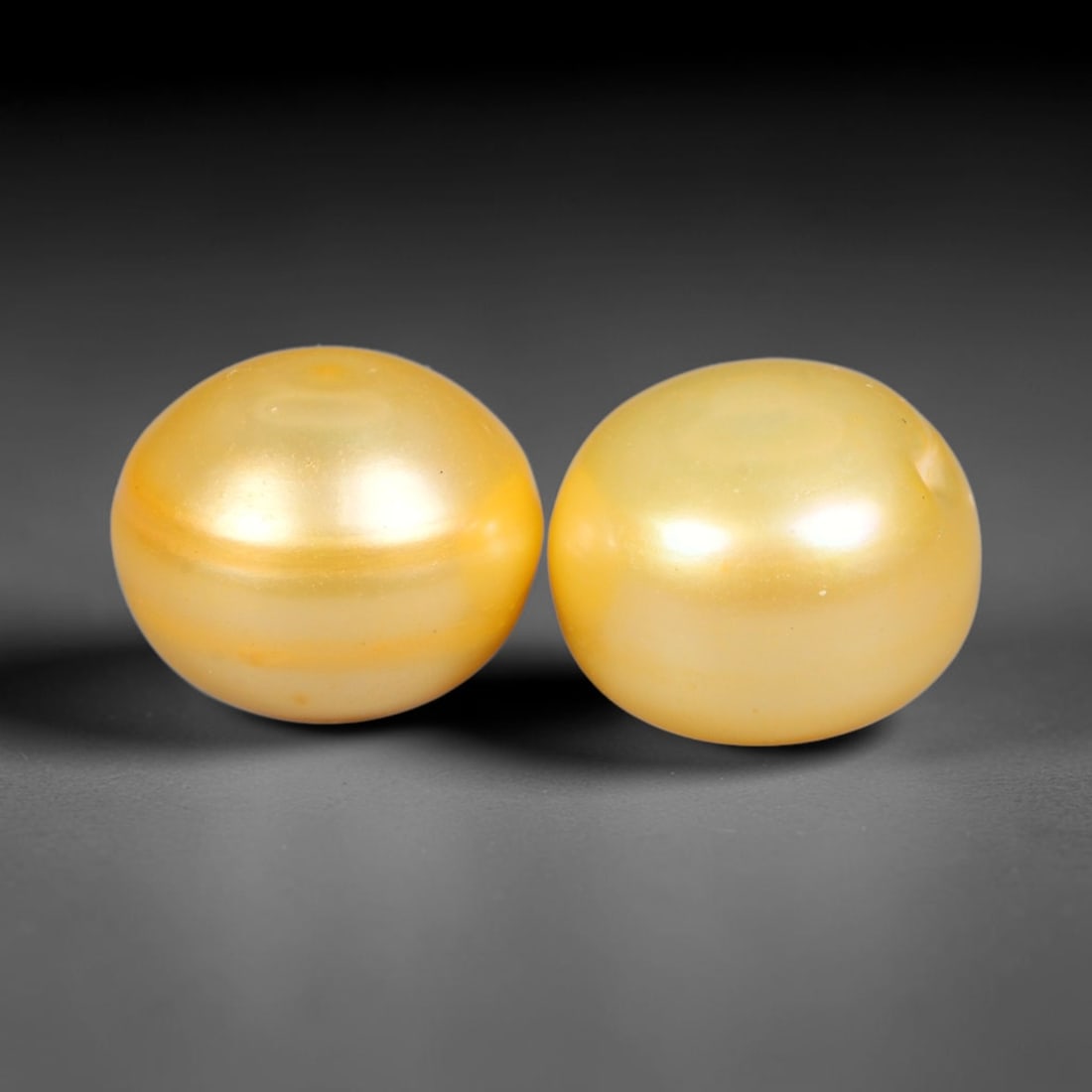 10.90ct Natural Warm Golden Yellow Orient Freshwater Half Round Pearl Pair, 51XZ: Matching pair of color-enhanced freshwater half-round pearls measuring 9.8x7.9mm each, crafted with smooth domed silhouettes ideal for earring mounting. The pearls feature a rich saturated warm golden
