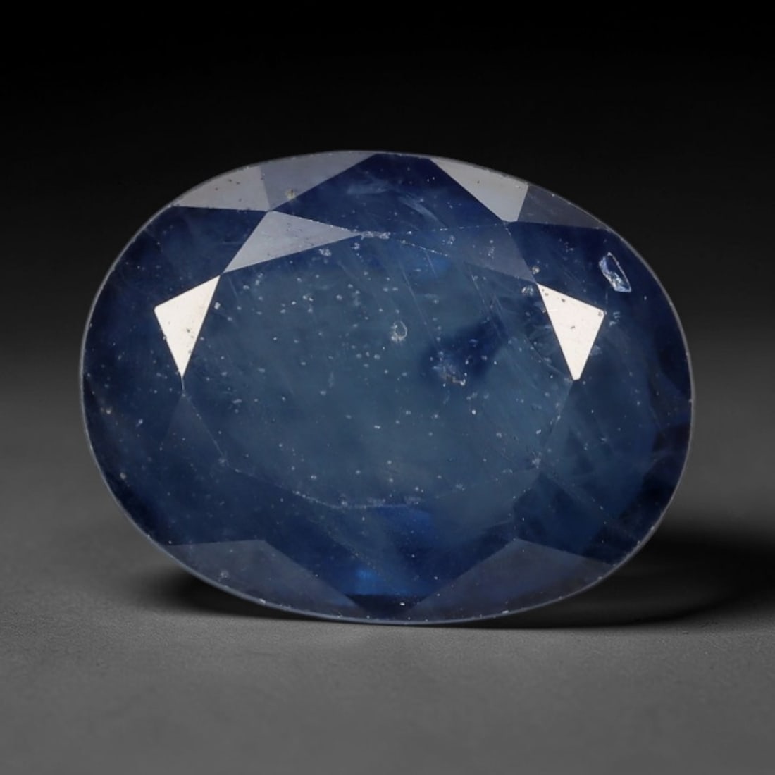 2.44ct Natural Soft Steel Blue Sapphire Oval Loose Faceted Gemstone, LZ301: This natural oval faceted sapphire weighs 2.44 carats with exact dimensions of 9.0x6.9x4.0mm. It delivers a tranquil soft steel-blue primary hue, layered with faint translucent greyish undertones and 