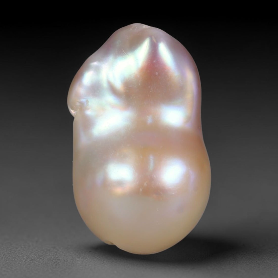 Natural Freshwater Keshi Pearl Baroque Loose Pearl, 88WE: This natural freshwater keshi pearl presents an organic irregular baroque silhouette with rich shifting iridescent nacre displaying soft champagne, peach and lavender overtones across its surface. Sub