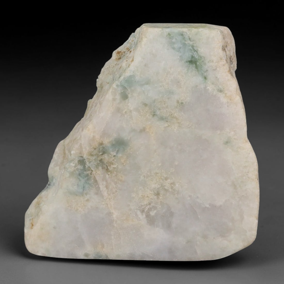 251ct Natural Type A Burmese Jadeite Jade Sliced Rough, 33YR: This specimen is a sliced rough block of natural Type A Burmese jadeite jade. The interior displays natural colour zoning with visible mineral veining and crystalline patterns typical of unprocessed j