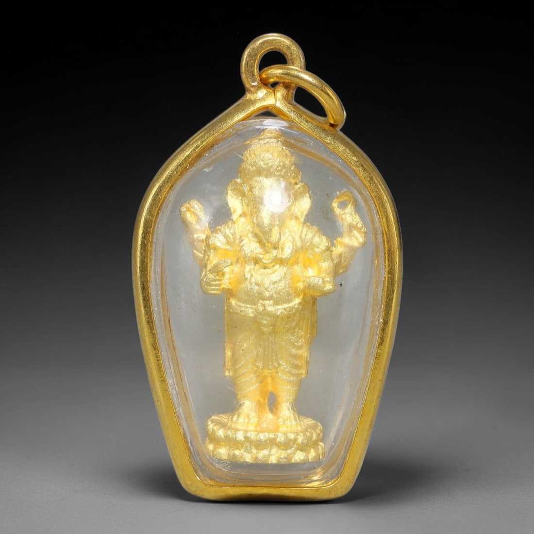 Thai Gold Plated Standing Four-Arm Ganesha Amulet Pendant With Clear Protective Casing, 81YY: Classic teardrop shaped gold plated frame amulet sized 3.5x2.0cm, fitted with double integrated gold jump rings for easy necklace stringing. Sealed transparent clear dome casing shields the miniature 