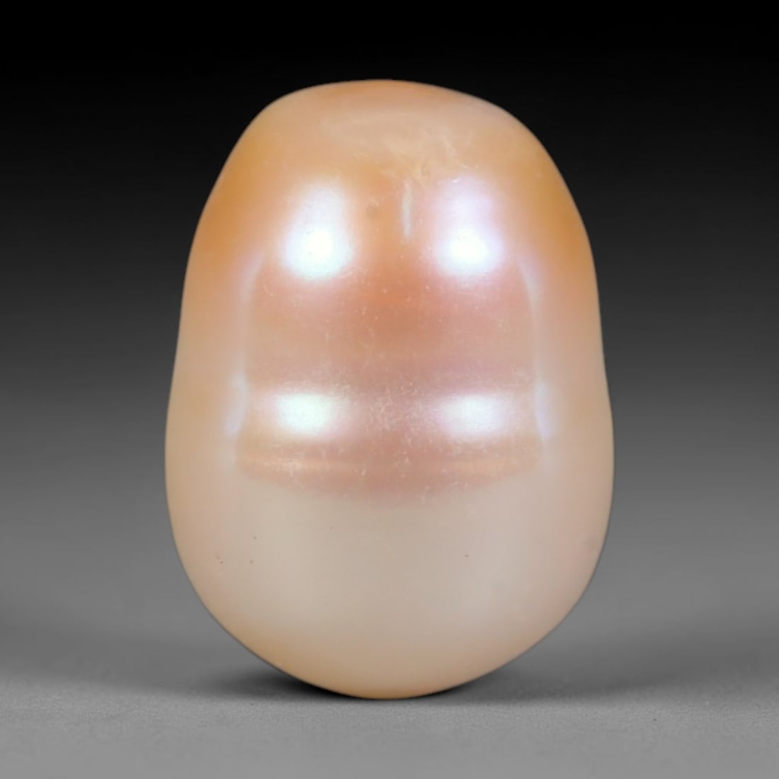 Natural Freshwater Baroque Pearl - Warm Apricot Cream Oval Organic Form, 70WE: This natural freshwater baroque pearl boasts a smooth soft oval organic silhouette wrapped in radiant iridescent nacre, blending warm apricot peach tones at the crown with pale creamy ivory across the