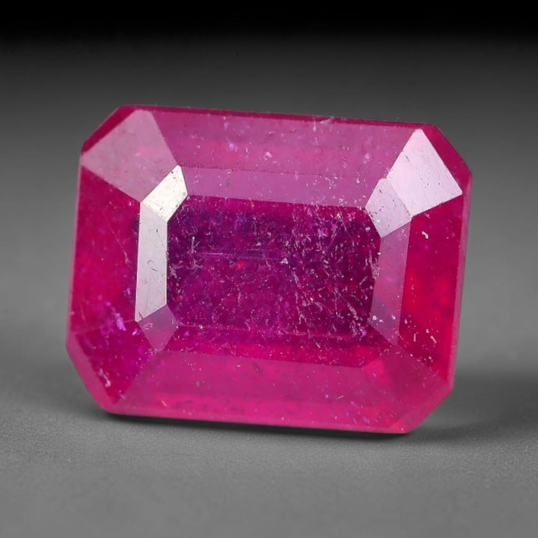 3.04 Carats Natural Madagascar Ruby Emerald Cut Loose Gemstone, 85XM: This natural Madagascar ruby is fashioned in a traditional emerald step faceted cut, showcasing deep saturated red tones typical of Malagasy corundum. Distinct natural internal fissures, fine mineral 