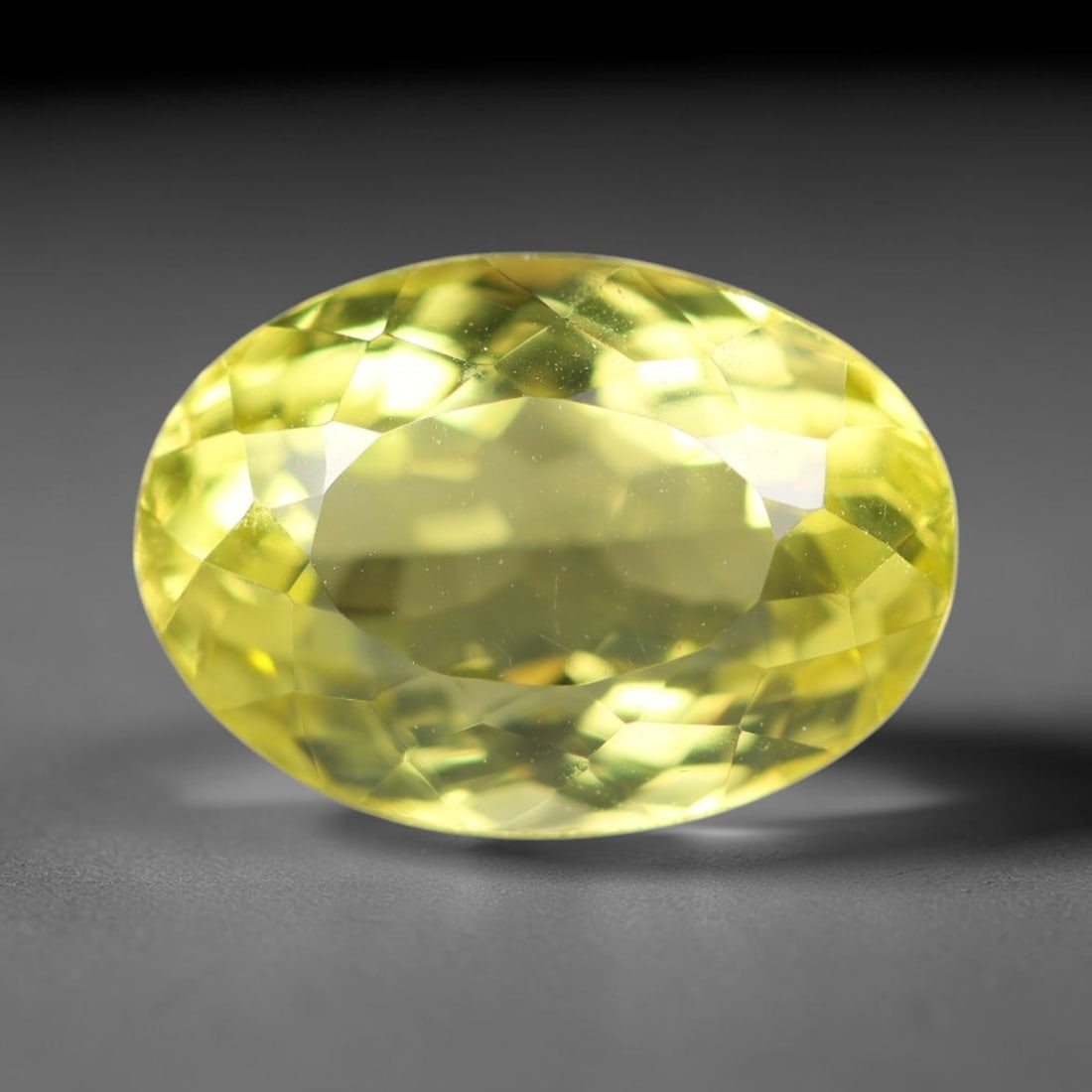 11.23 Carats Natural Brazilian Lemon Quartz Oval Faceted Loose Gemstone, 6XX: This lemon quartz is sourced from natural mineral deposits within Brazil and refined through standard professional faceted lapidary procedures, accompanied by uniform glossy polishing across the full 