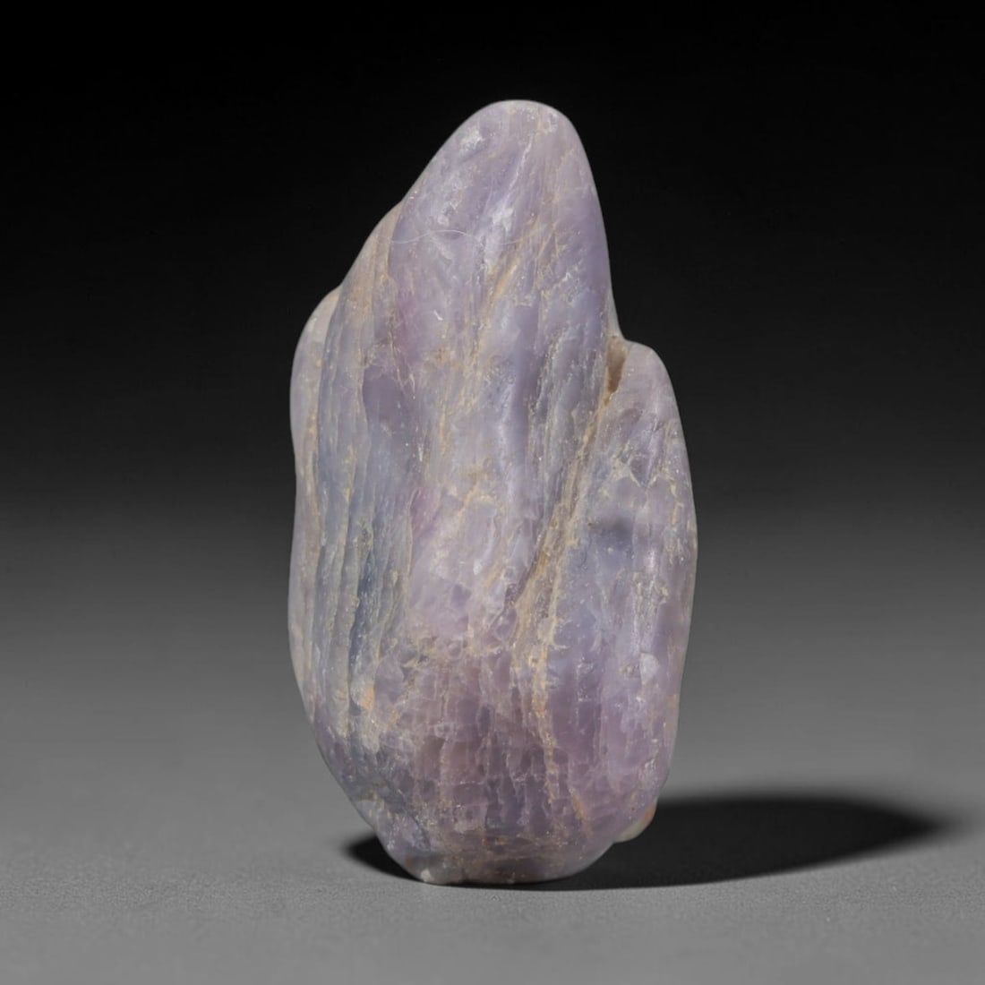 28ct Natural Unheated Sri Lankan Purplish Blue Sapphire Rough, 87YQ: This natural corundum rough is an unheated purplish blue sapphire sourced from Sri Lankan alluvial gem deposits, featuring an irregular natural native form with residual pale yellow-brown mineral matr