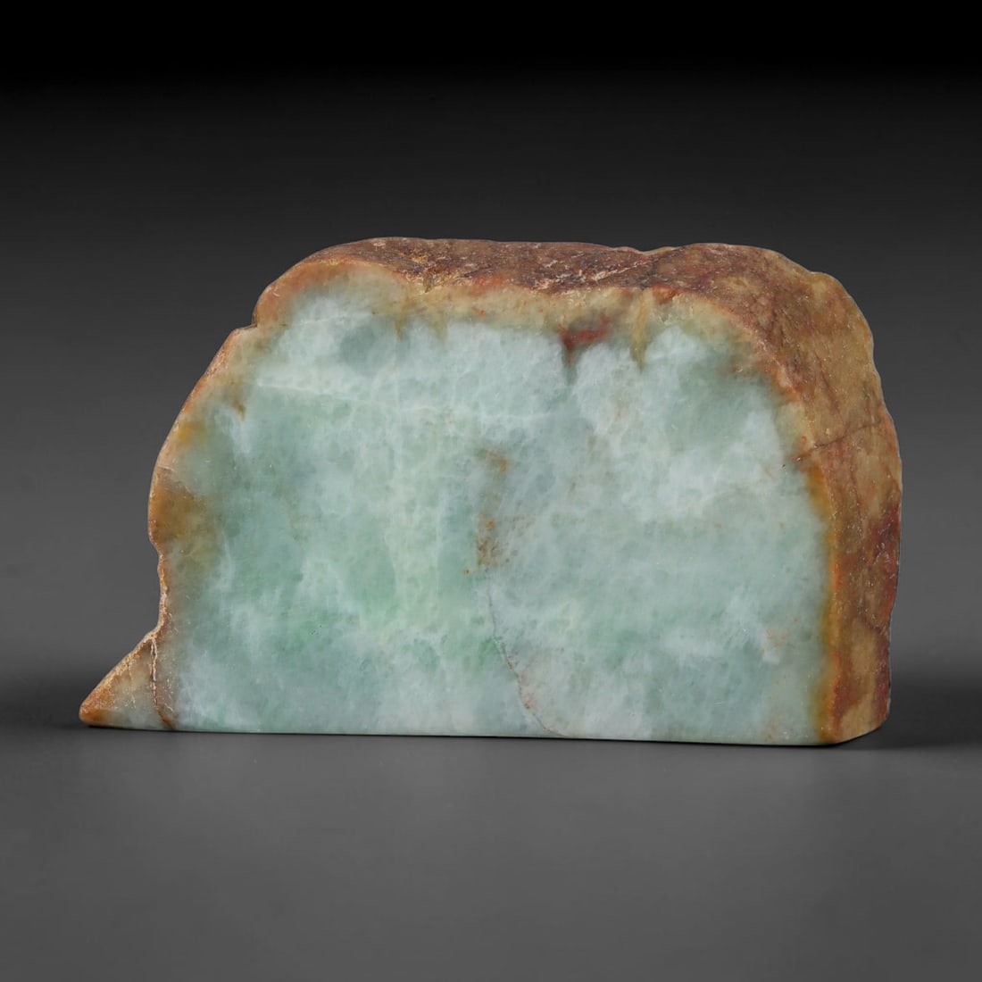 385ct Natural Type A Burmese Jadeite Jade Sliced Rough, 63YK: This specimen is a sliced rough block of natural Type A Burmese jadeite jade. The interior displays natural colour zoning with visible mineral veining and crystalline patterns typical of unprocessed j