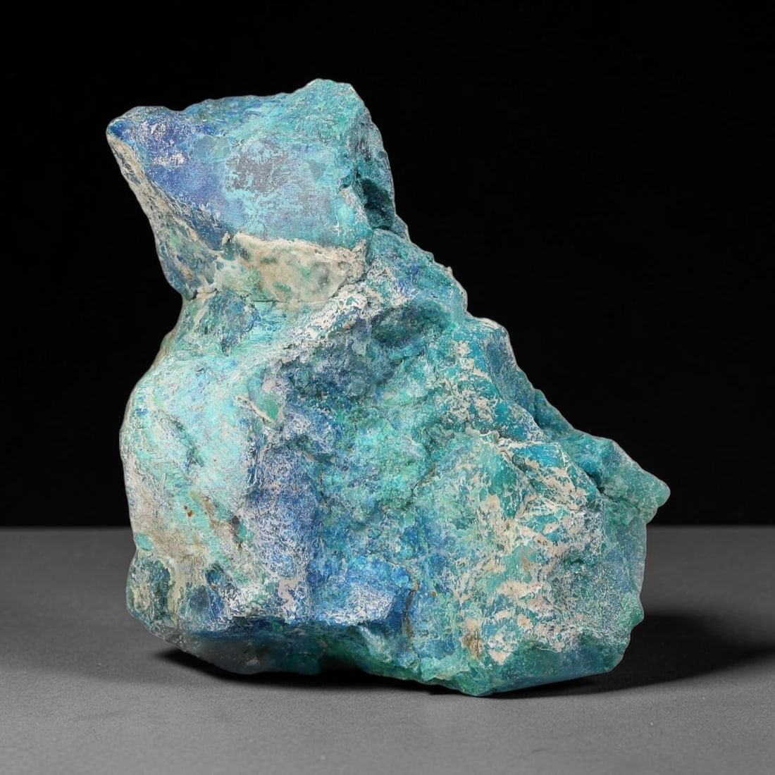 86ct Natural Peruvian Chrysocolla Polished Slab Rough, 64WV: This partial-polished chrysocolla slab features blended mineral matrix with smooth refined face and unaltered natural rugged edge across its 39x28x15mm elongated form, translucent mineral layers hold 