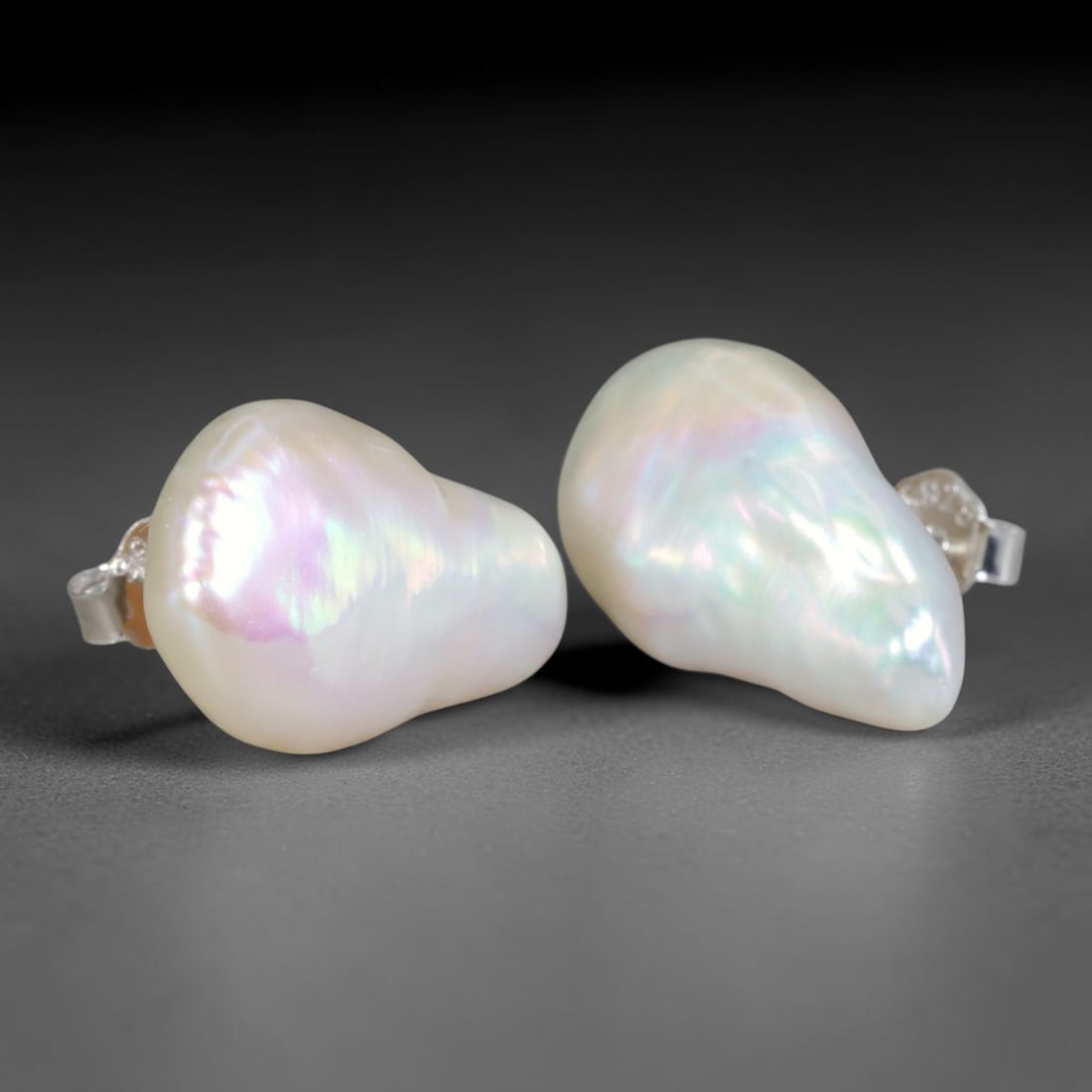 Natural Baroque Asymmetric Teardrop Pearl Stud Earrings, 3WS: Matched minimalist stud earrings featuring unique organic asymmetrical teardrop baroque freshwater pearls with dimensions of 16.3x5.8mm each. Thick glossy natural nacre forms a milky ivory base, illum