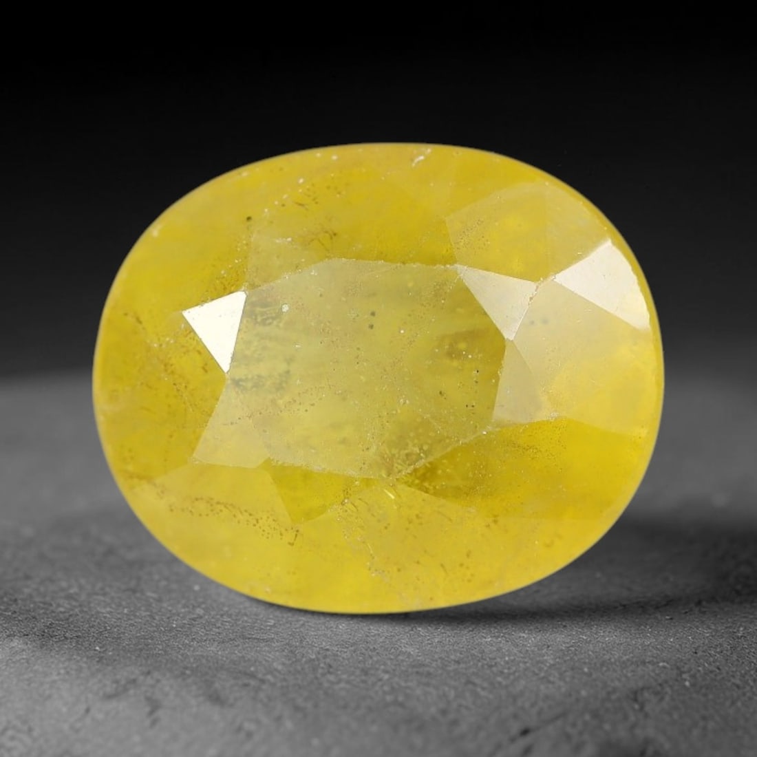 3.96 Carats Natural Yellow Sapphire Oval Faceted Loose Gemstone, 53XM: This natural yellow sapphire features a classic oval brilliant faceted cut, holding consistent warm golden-yellow color throughout the corundum crystal. Fine microscopic mineral specks and faint natur