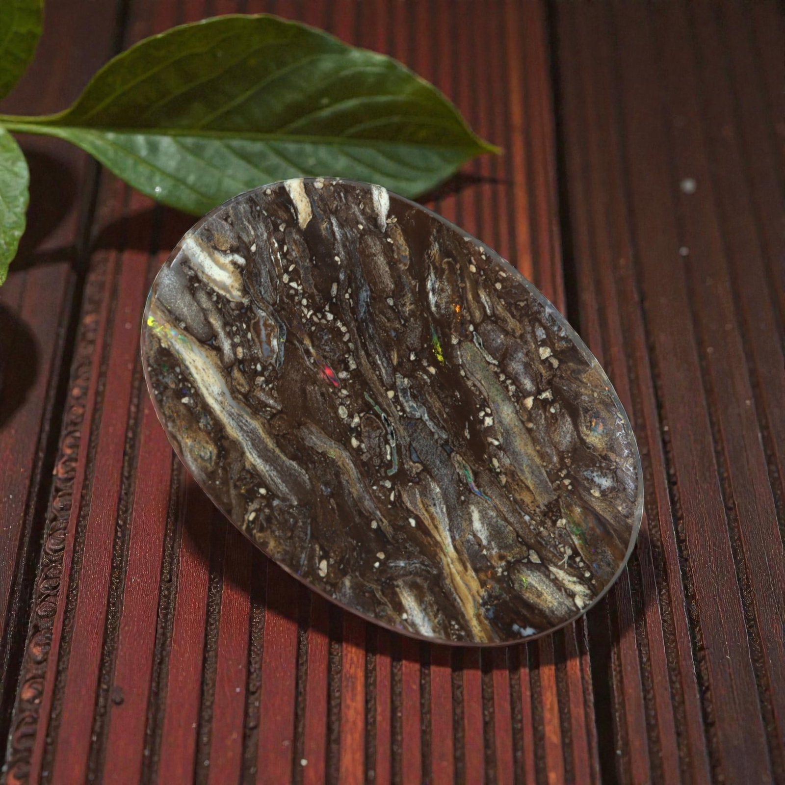 10.40 Carats Brown Matrix Multicolor Koroit Yowah Opal Cabochon - Natural Australian Stone, 20XM: This singular Koroit Yowah opal cabochon presents a striking natural tableau, with a rich brown ironstone matrix interwoven with delicate veins and flecks of iridescent opal. The stone's oval form sho