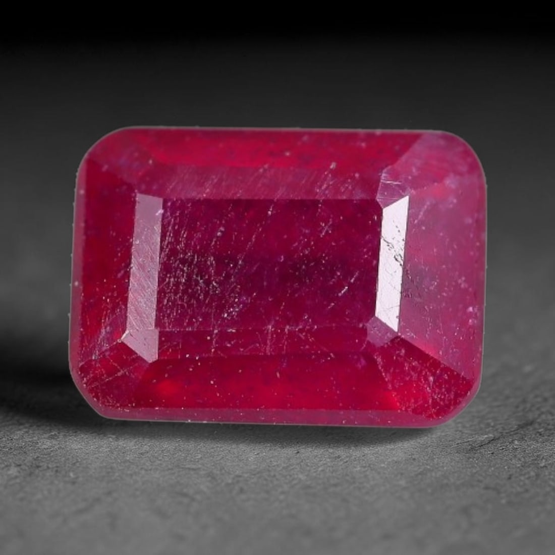 1.93 Carats Natural Madagascar Ruby Emerald Cut Loose Gemstone, 70XM: This natural Madagascar ruby is fashioned in a traditional emerald step faceted cut, showcasing deep saturated red tones typical of Malagasy corundum. Distinct natural internal fissures, fine mineral 