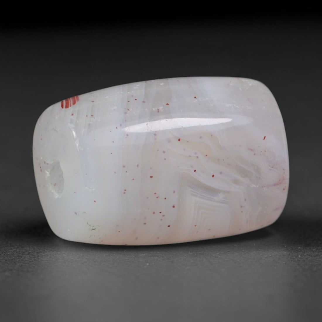 Ancient Gandhara Red Speckled White Banded Agate Short Barrel Amulet Bead (600 BCE - 500 CE), 47XD: This stout miniature short barrel agate bead originates from Gandhara cross-cultural stone workshops, crafted as compact protective talismans for Buddhist devotees and Silk Road traders. The transluce